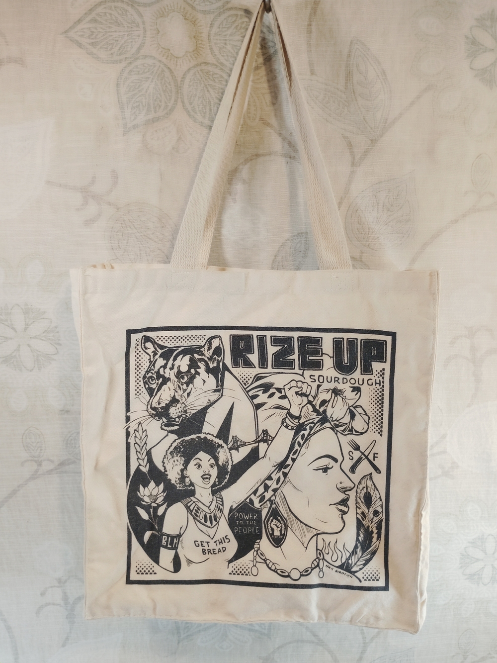 Rize Up Bakery Cream Canvas Tote Bag with Black Graphic Print